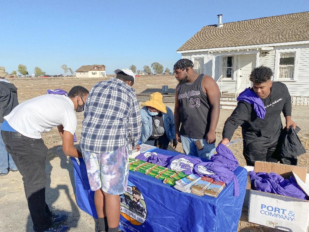 Volunteers distributing race shirts and materials at the registration table